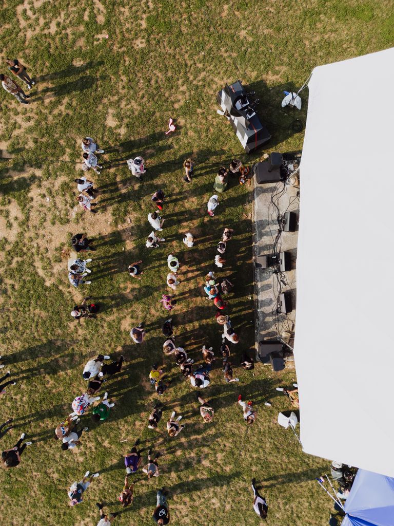 Drone shot capturing a vibrant crowd at an outdoor concert in Chattanooga.