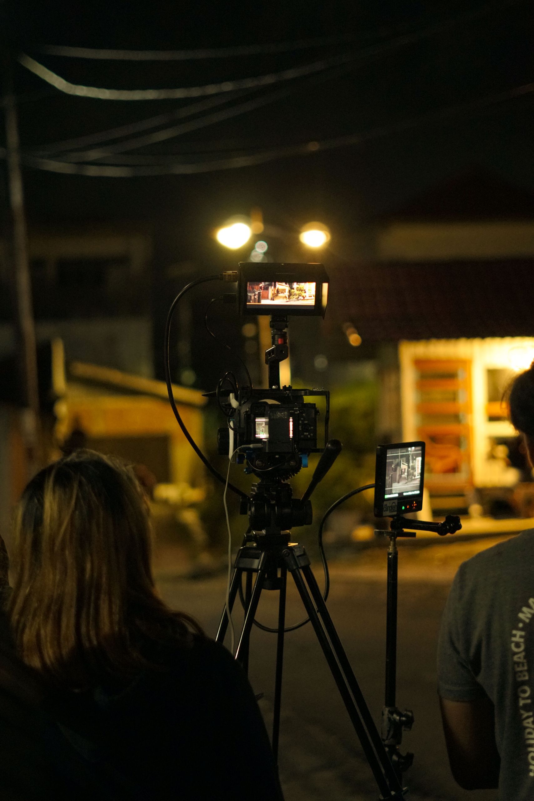 Filmmakers recording at night on a bustling street in Padang, Indonesia.
